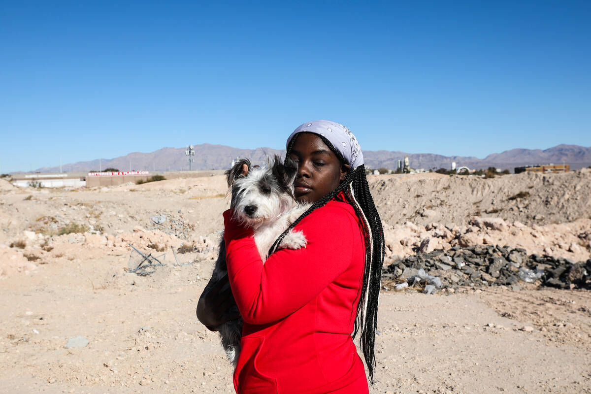 Z’kya Smith, 15, left, carries her cousin’s dog Magic on Sunday, Jan. 30, 2022 in ...