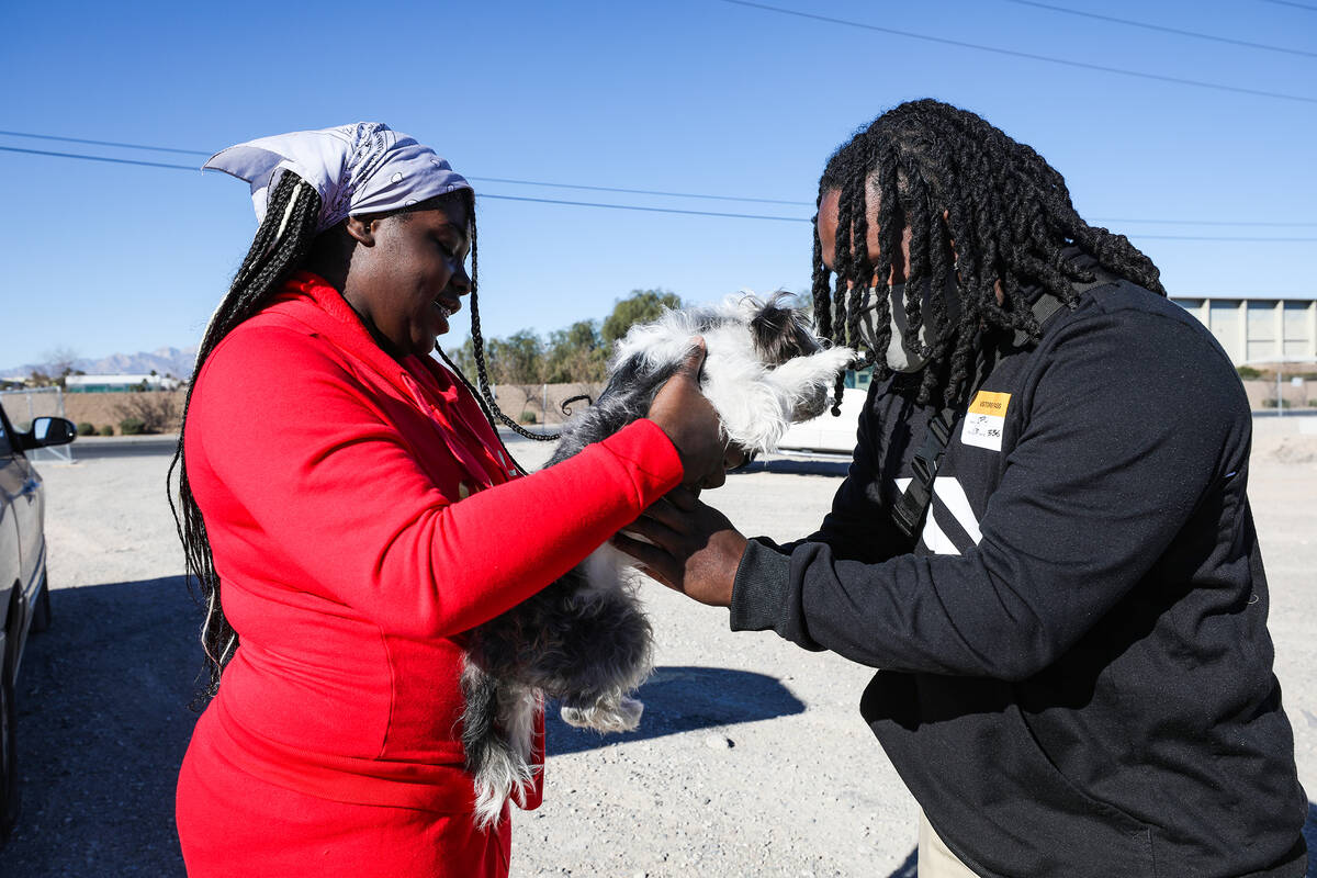 Z’kya Smith, 15, left, reunites Chris Noel with his dog Magic, who was traveling with No ...