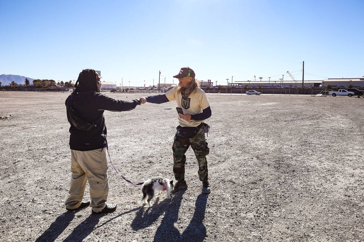 Chris Noel, left, thanks volunteer Kelly Winder, right, who helped find his dog Magic, who was ...