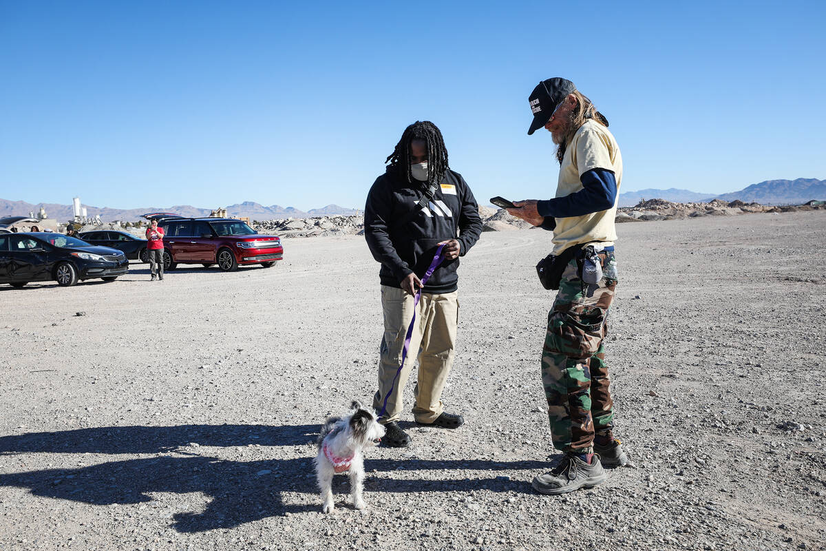 Chris Noel, left, thanks volunteer Kelly Winder, right, who helped find his dog Magic, who was ...