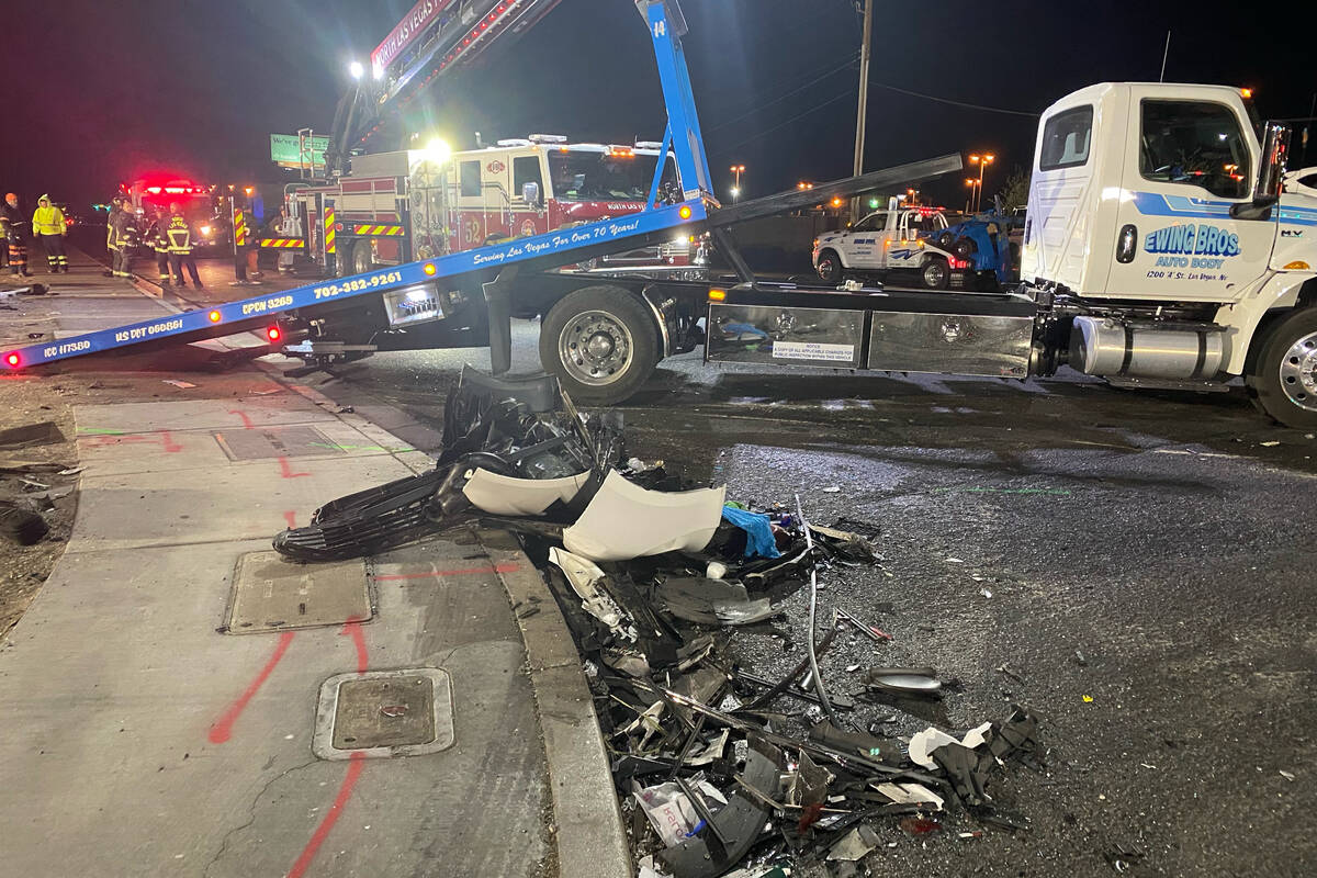 Authorities get set to tow a vehicle at the scene of a fatal crash on West Cheyenne Avenue in N ...