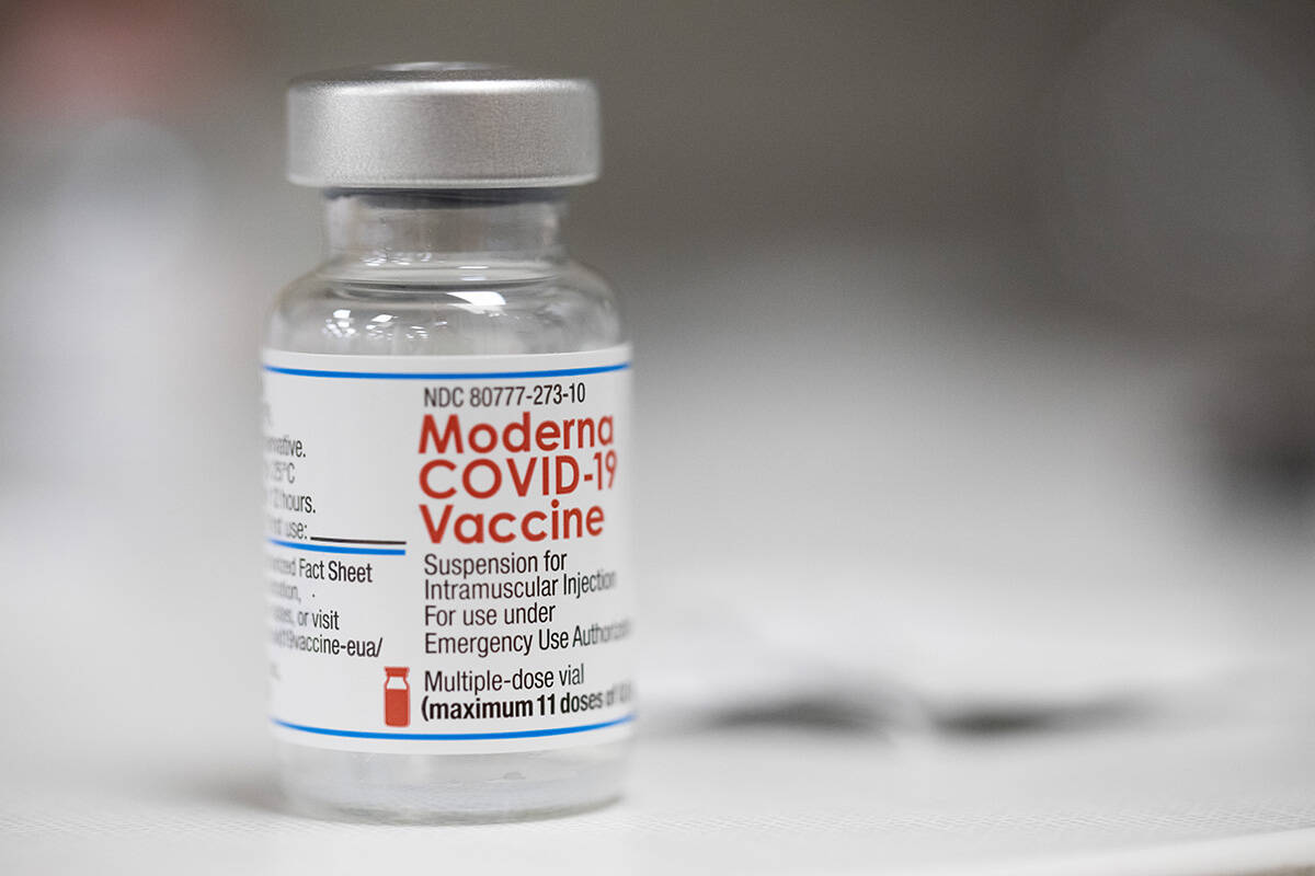 A vial of the Moderna COVID-19 vaccine is displayed on a counter at a pharmacy in Portland, Ore ...