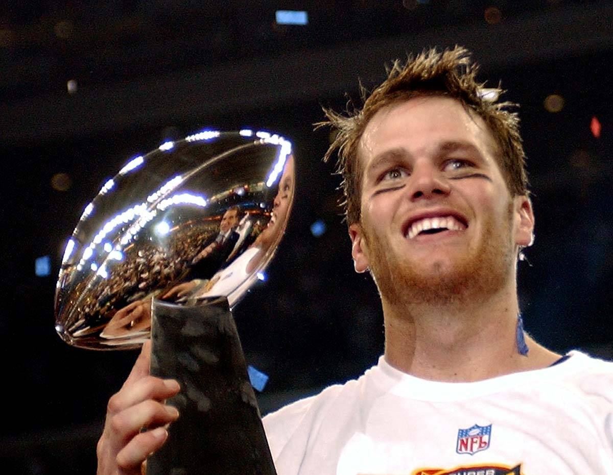 New England Patriots quarterback Tom Brady holds the Vince Lombardi Trophy after the Patriots b ...