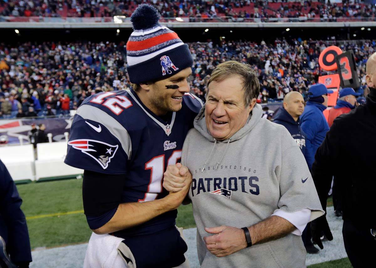 New England Patriots quarterback Tom Brady, left, celebrates with head coach Bill Belichick aft ...