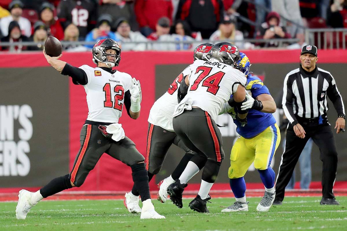 Tampa Bay Buccaneers quarterback Tom Brady (12) passes the ball as Tampa Bay Buccaneers guard A ...