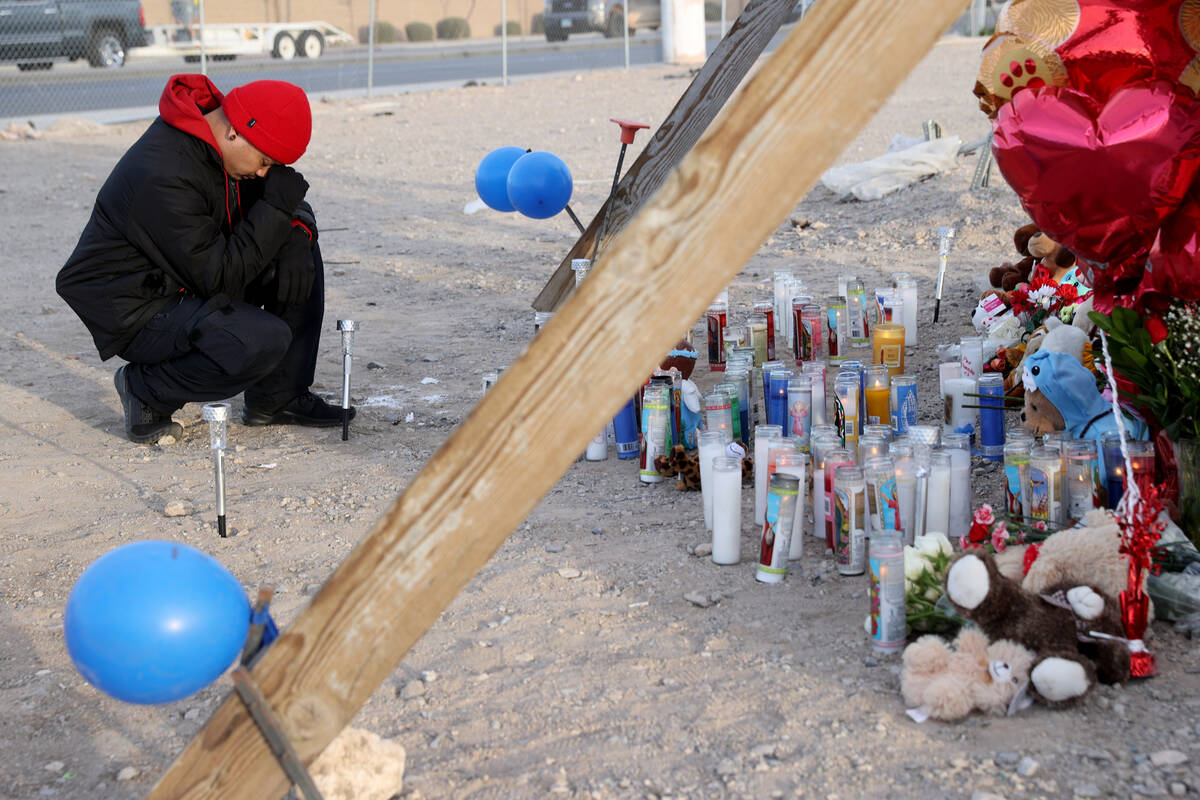 Joseph Dollopac of North Las Vegas prays at memorial to the victims of six-vehicle crash that l ...