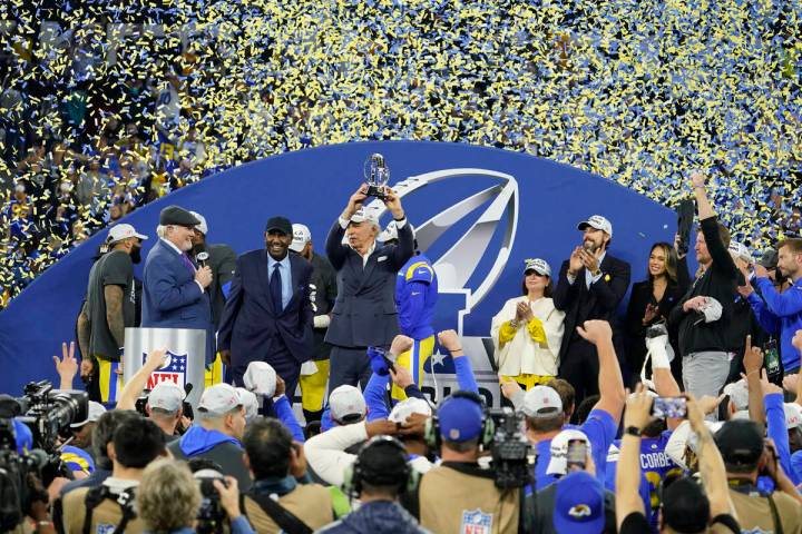 Los Angeles Rams owner Stan Kroenke, middle, holds up the George Halas trophy after the Rams de ...