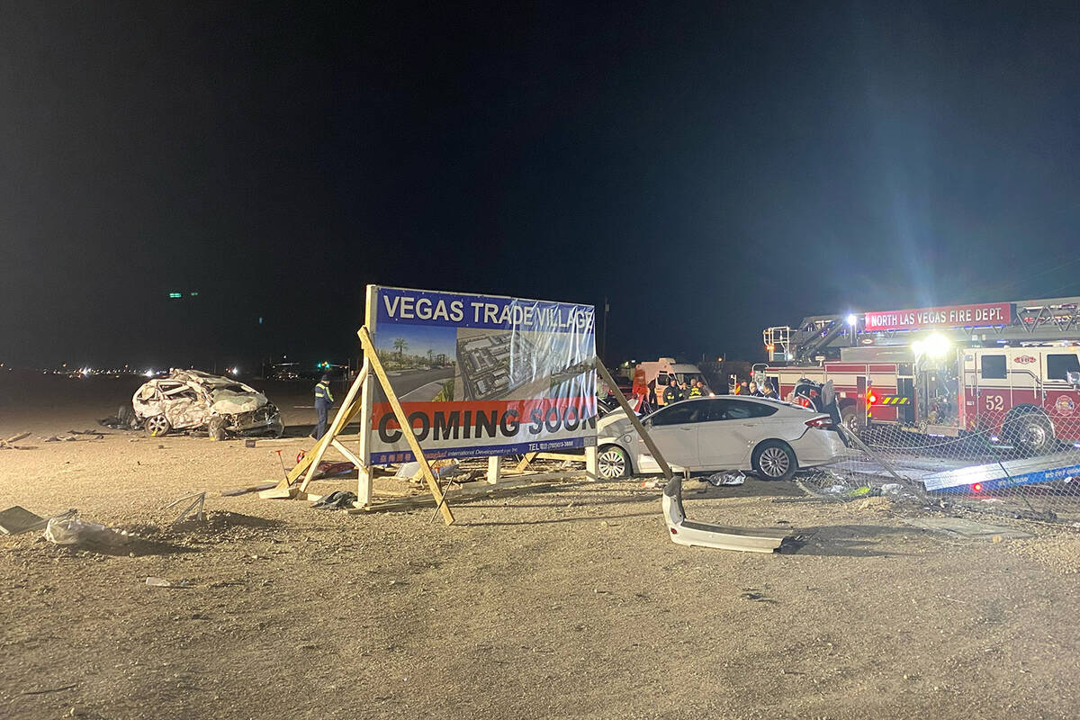 Emergency personnel work at the scene of a six-vehicle crash on West Cheyenne Avenue in North L ...