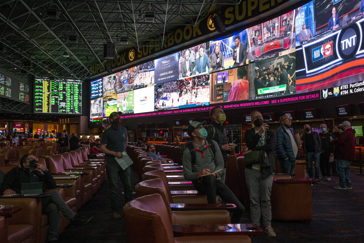 Bettors eye the board as Super Bowl prop bets are released at the Westgate SuperBook on Thursda ...