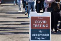 People line up to get tested for COVID-19 outside of the West Flamingo Senior Center on Tuesday ...