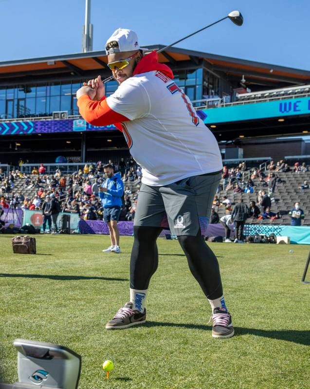 Buffalo Bills tackle Dion Dawkins readies to hit a golf ball in a driving skills game during AF ...