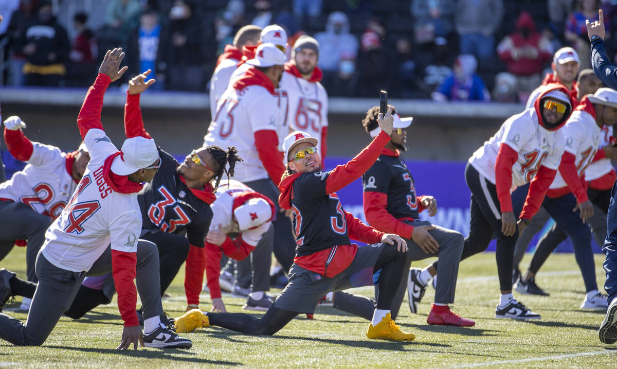 Kansas City Chiefs safety Tyrann Mathieu (32) takes a photo of himself and teammates while warm ...