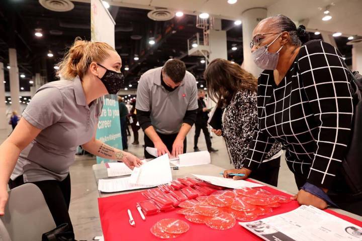 Job seeker Cheryl Robinson of Las Vegas, right, talks to Jennifer Brooklyn of Walgreens during ...