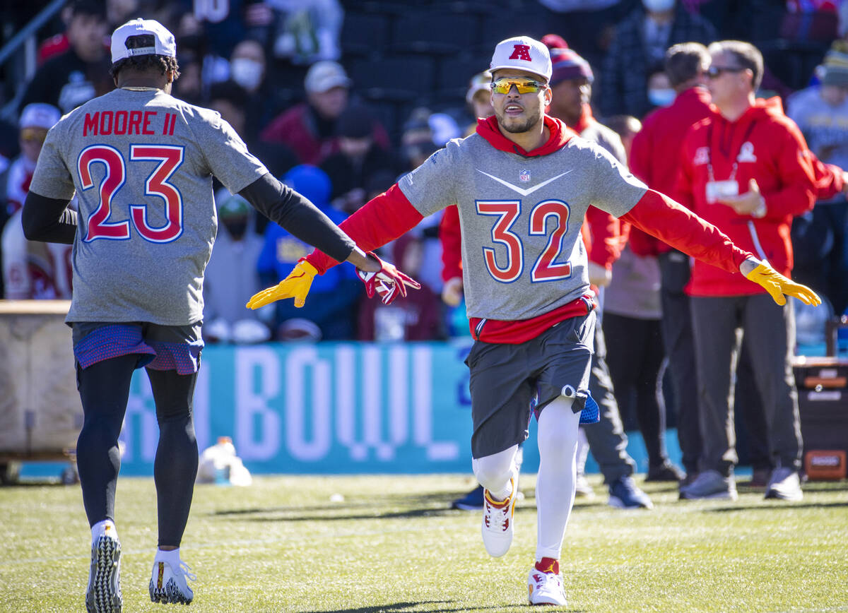 Kansas City Chiefs Tyrann Mathieu (32) greets teammate Indianapolis Colts Kenny Moore II (23) w ...