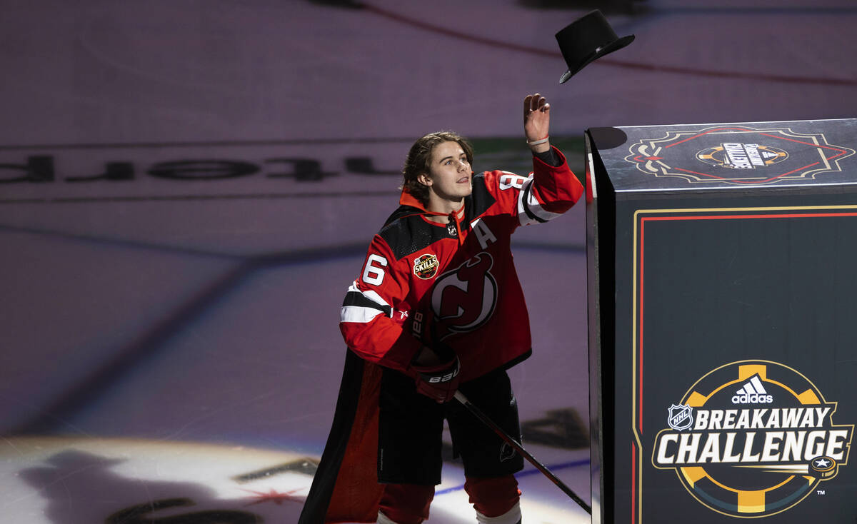 New Jersey Devils center Jack Hughes (86) performs a magic trick during the NHL All-Star skills ...