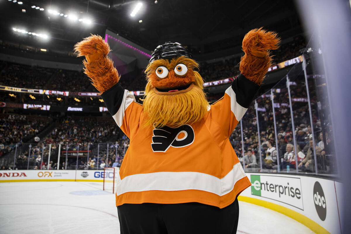 Philadelphia Flyers mascot Gritty waves to fans during the NHL All-Star Game on Saturday, Feb. ...