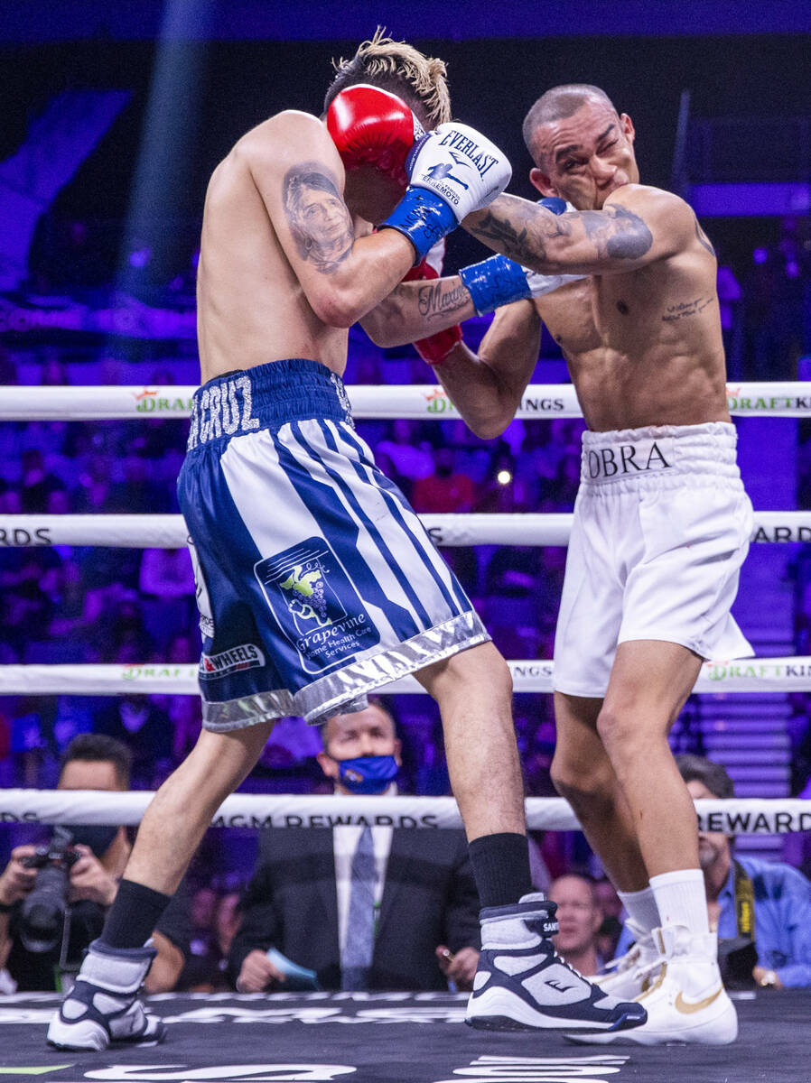 Leo Santa Cruz, left, connects with the chin of Keenan Carbajal during the second round of thei ...