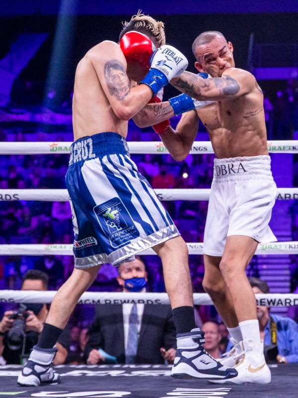 Leo Santa Cruz, left, connects with the chin of Keenan Carbajal during the second round of thei ...