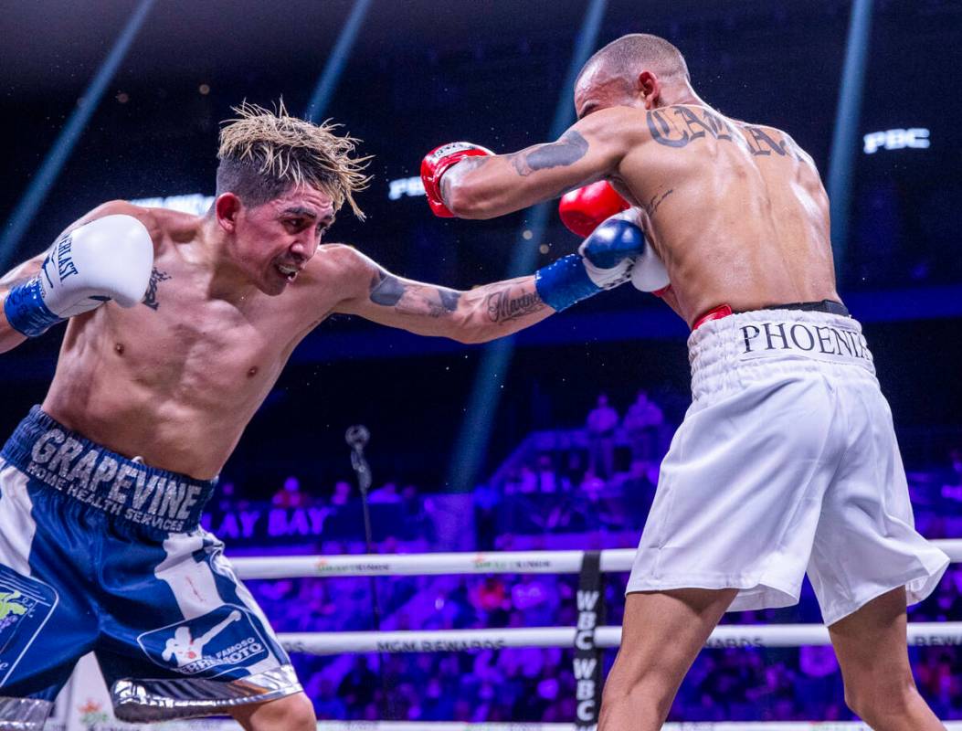 Leo Santa Cruz, left, connects with the ribs of Keenan Carbajal during the fourth round of thei ...