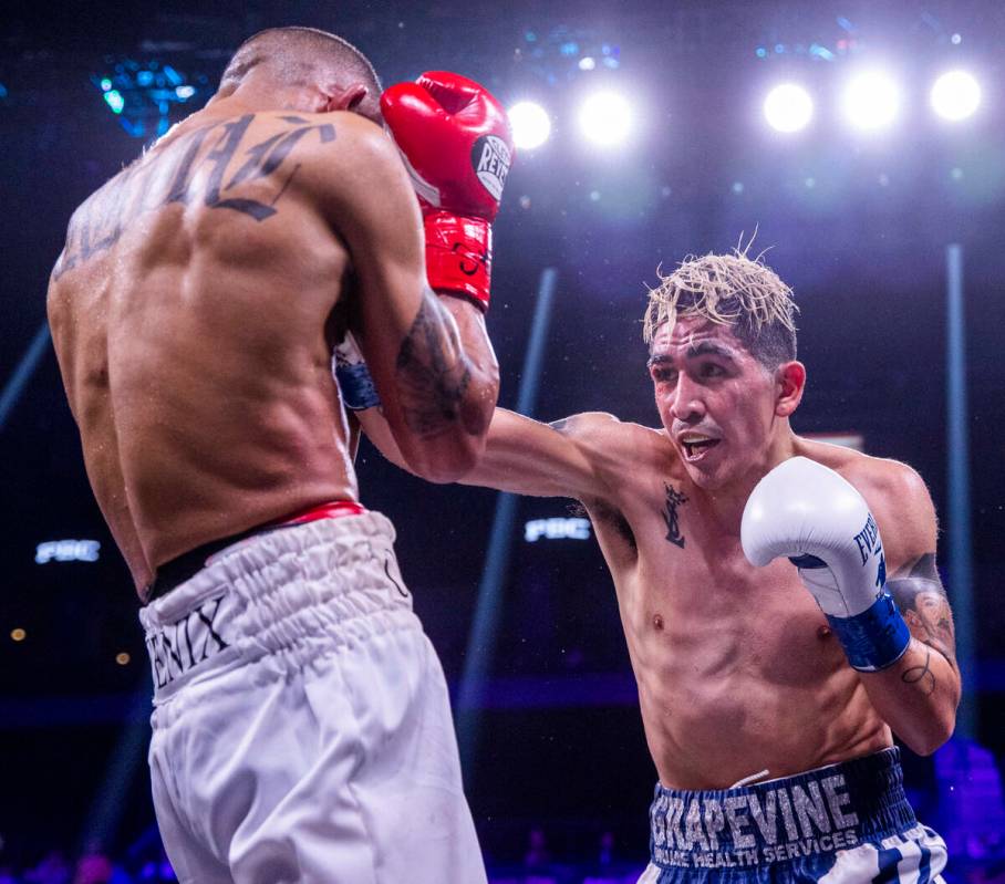 Keenan Carbajal, left, is struck by Leo Santa Cruz during the fifth round of their super feathe ...