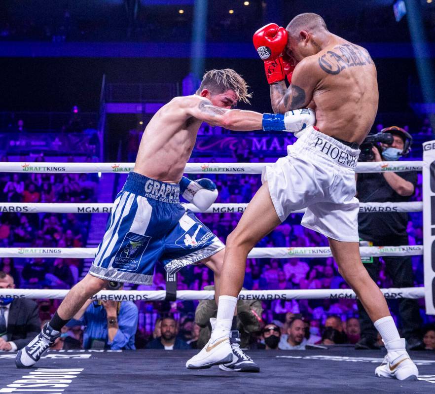 Leo Santa Cruz, left, connects with the ribs of Keenan Carbajal during the seventh round of the ...