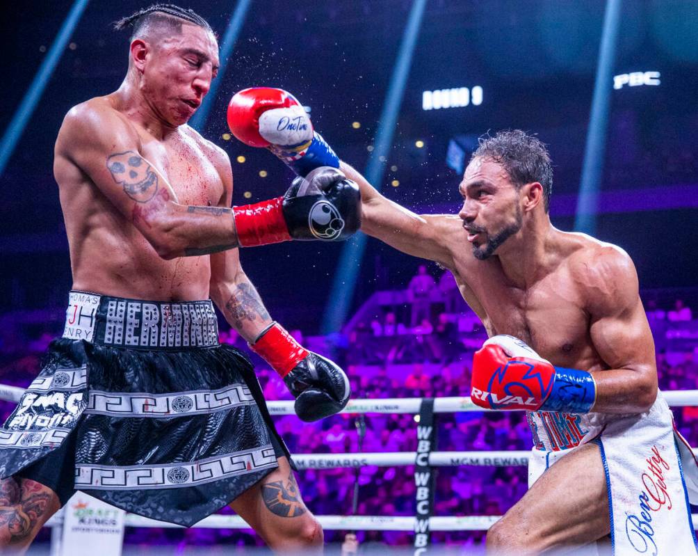 Mario Barrios, left, takes a punch to the face from Keith Thurman during the ninth round of the ...