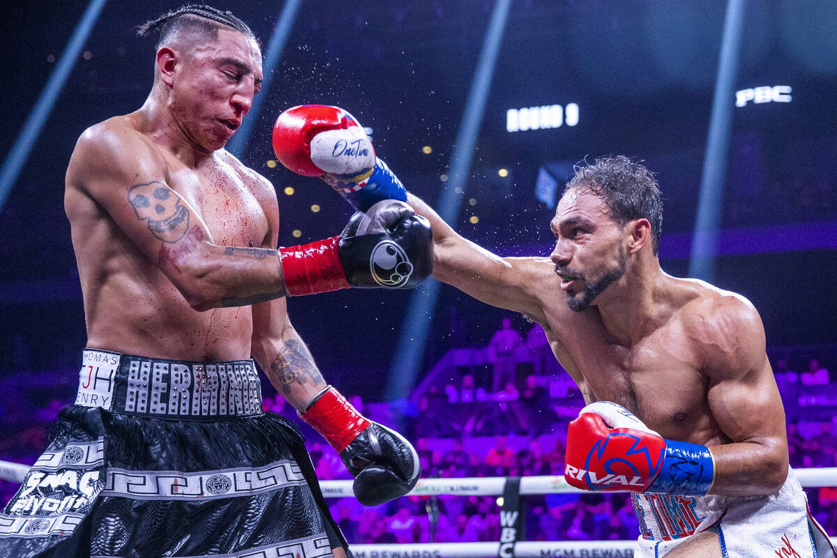 Mario Barrios, left, takes a punch to the face from Keith Thurman during the ninth round of the ...