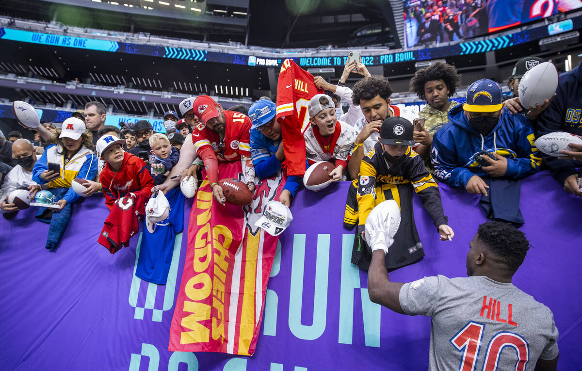 AFC wide receiver Tyreek Hill of the Kansas City Chiefs (10) signs autographs for fans during w ...