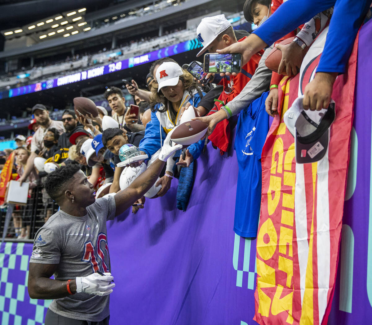 AFC wide receiver Tyreek Hill of the Kansas City Chiefs (10) signs autographs for fans during w ...
