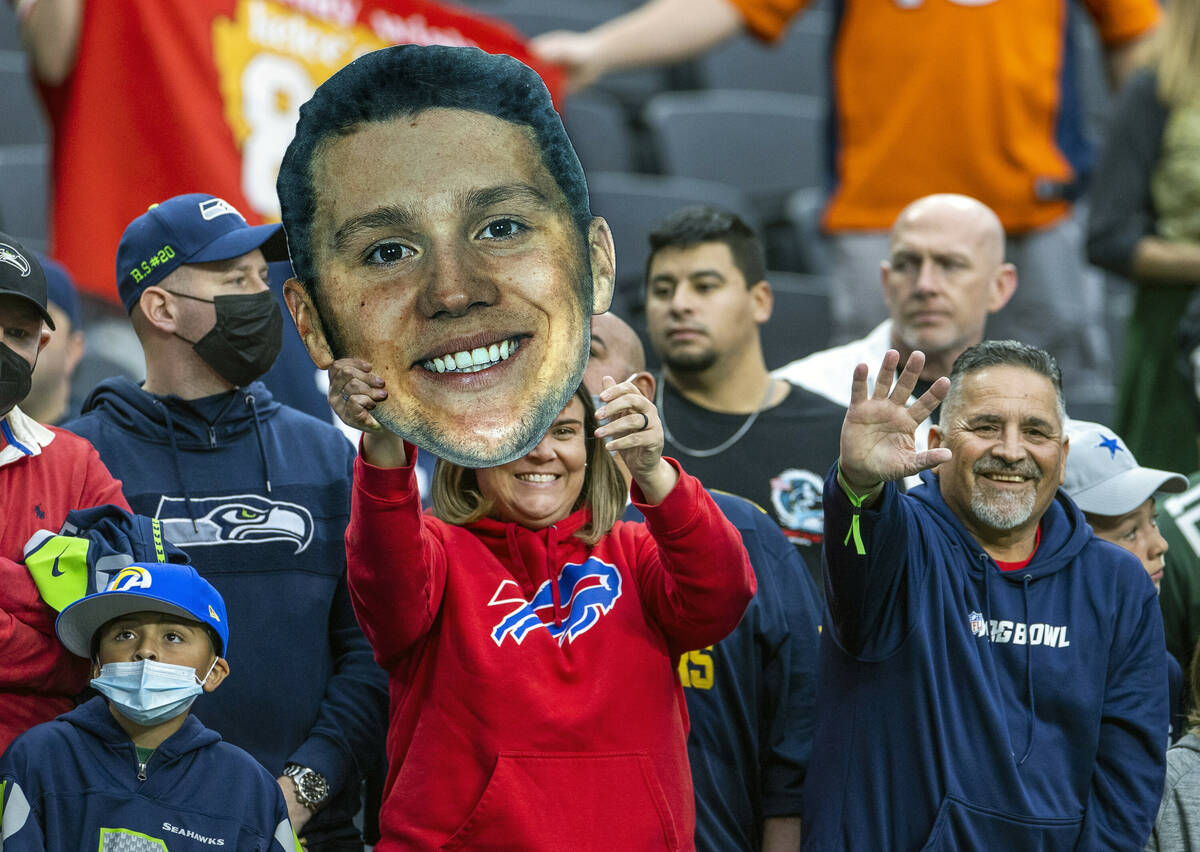 A fan holds up a giant head of Buffalo Bills quarterback Josh Allen during warm ups before the ...