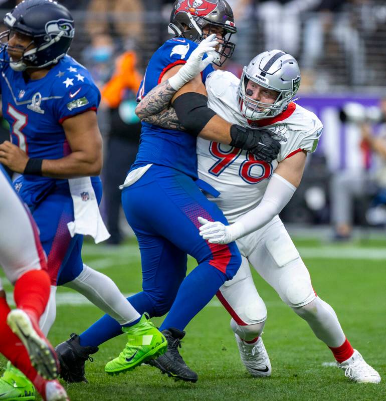 AFC defensive end Maxx Crosby of the Las Vegas Raiders (98) battles to get free of a hold by NF ...