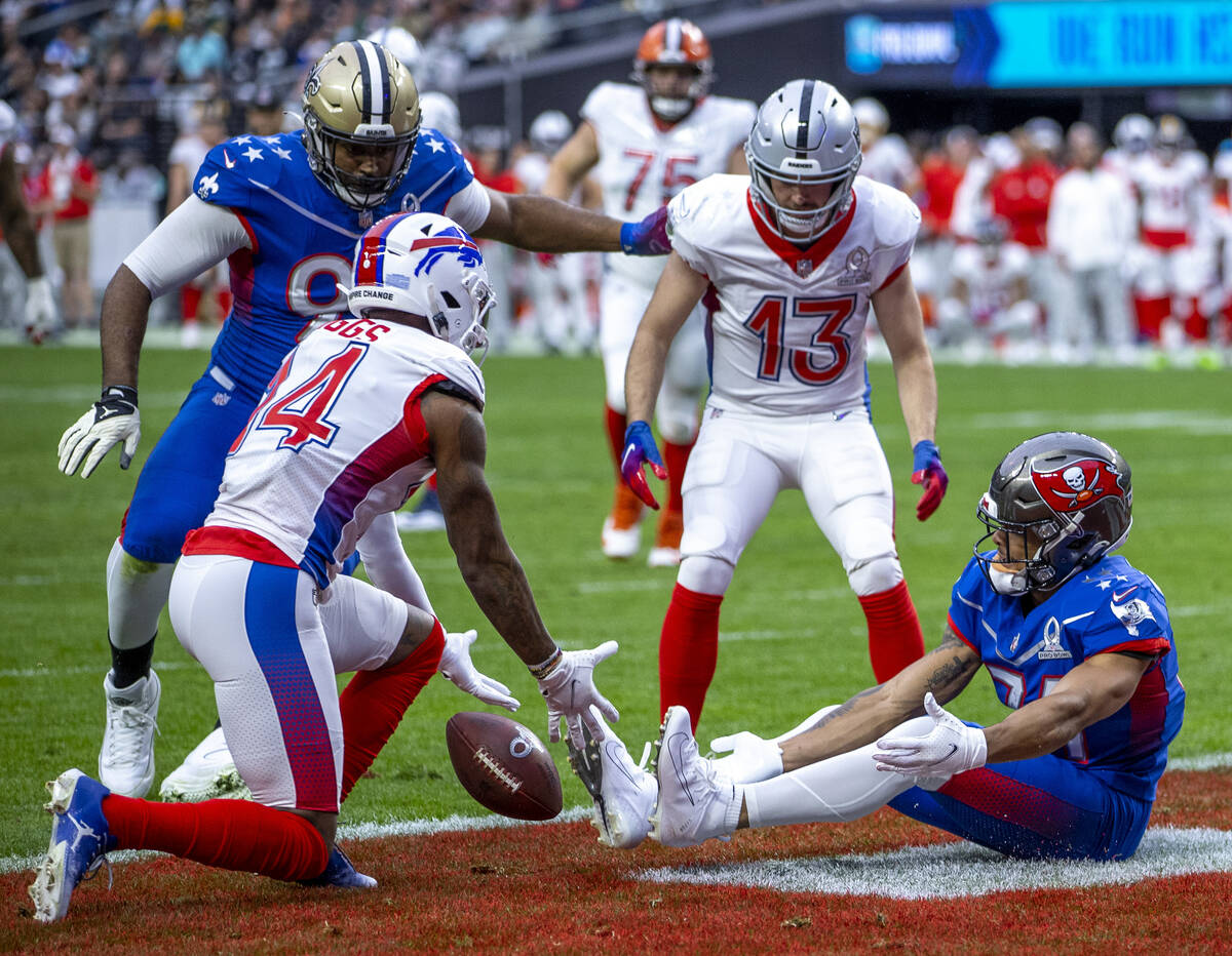 AFC receiver Stefon Diggs with the Buffalo Bills (14, left) looks to catch a reflection intende ...