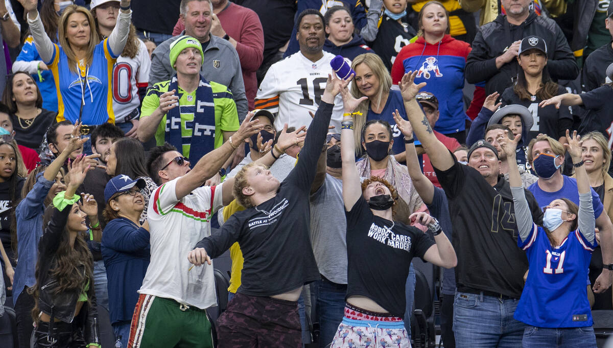 Fans reach for a t-shirt tossed into the stands during the first half of the Pro Bowl at Allegi ...