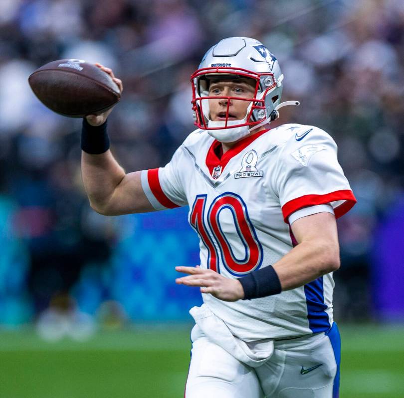 AFC quarterback Mac Jones of the New England Patriots (10) looks for a receiver versus the NFC ...