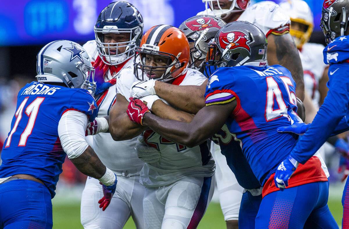 AFC running back Nick Chubb of the Cleveland Browns (24) is wrapped up by NFC inside linebacker ...