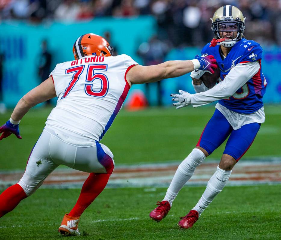 AFC guard Joel Bitonio of the Cleveland Browns (75) attempts to grab the ball from NFC cornerba ...