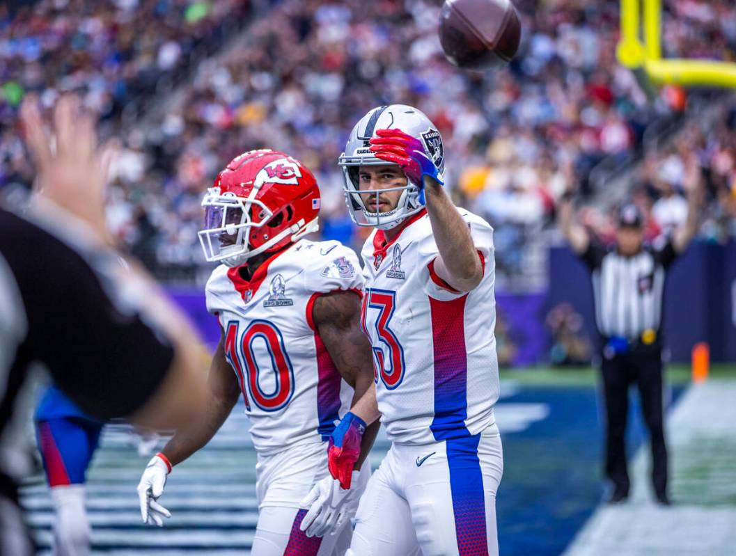 AFC wide receiver Hunter Renfrow of the Las Vegas Raiders (13) tosses a ball back after scoring ...