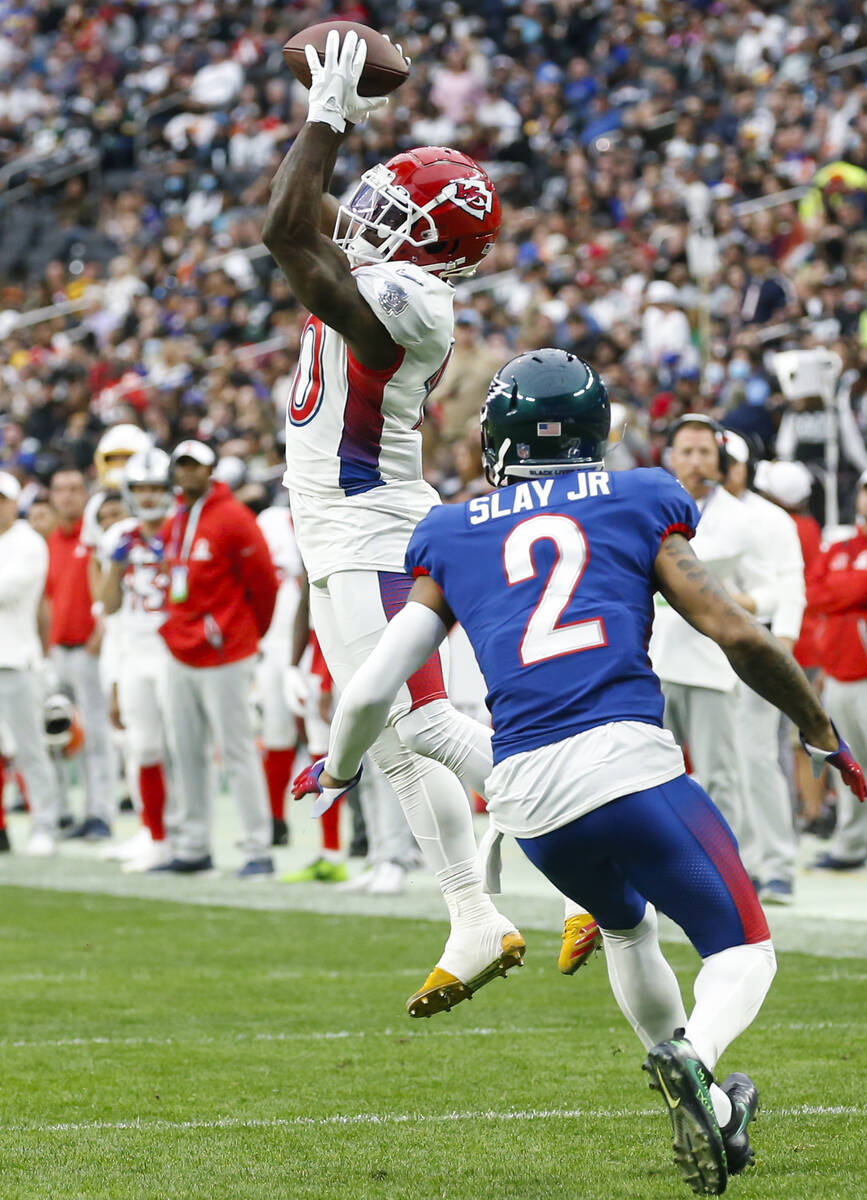 AFC wide receiver Tyreek Hill of the Kansas City Chiefs (10) catches the ball under pressure fr ...