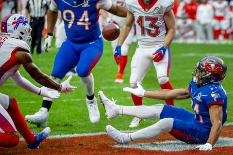 AFC receiver Stefon Diggs with the Buffalo Bills (14, left) looks to catch a reflection between ...