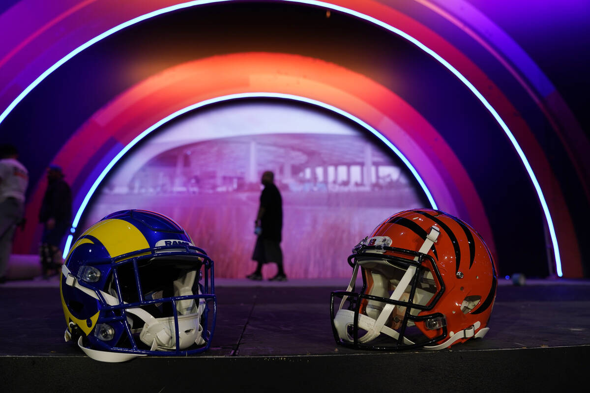 Los Angeles Rams and Cincinnati Bengals helmets rest on a stage inside the NFL Experience, an i ...