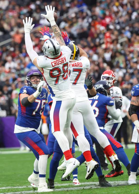 AFC defensive end Maxx Crosby of the Las Vegas Raiders (98) blocks a pass from NFC quarterback ...