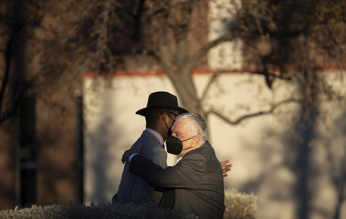 Gov. Steve Sisolak, right, greets minister Stretch Sanders during an event honoring the victims ...