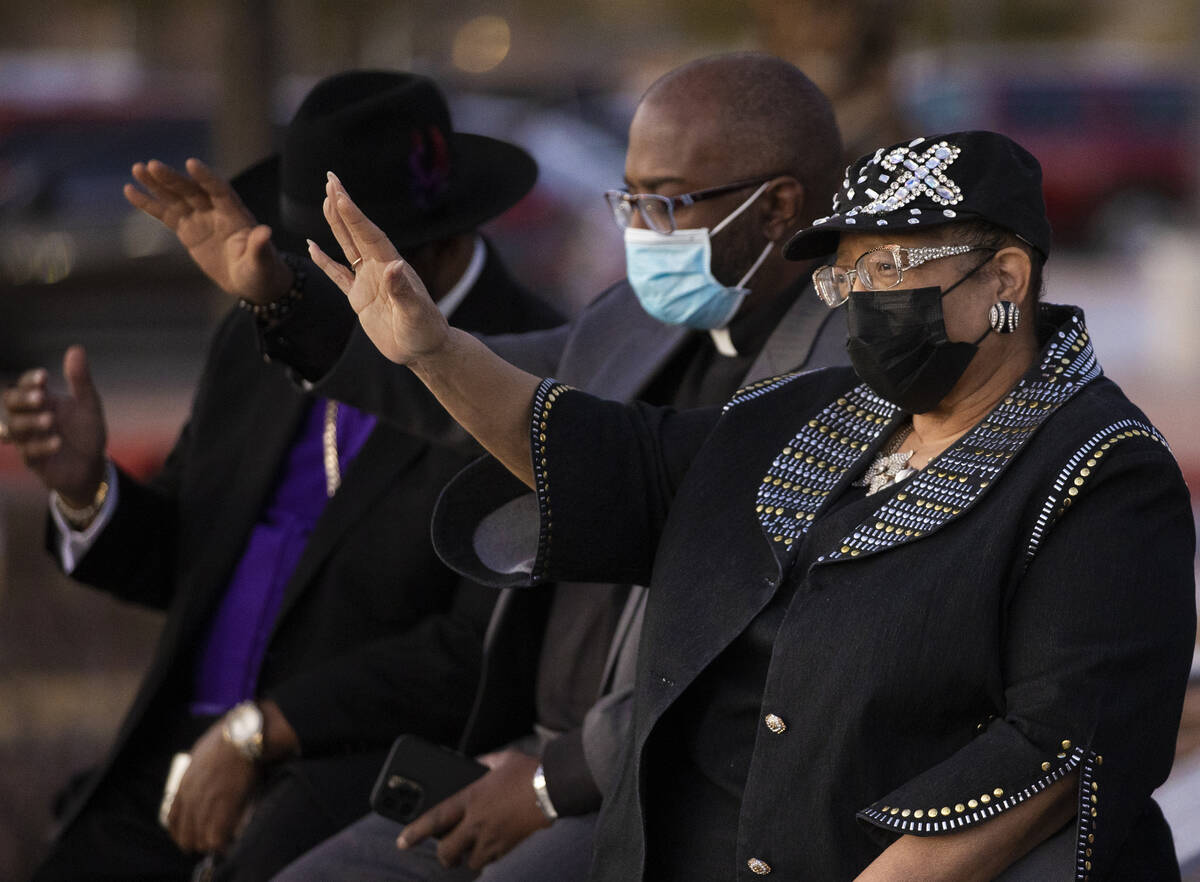 Dr. Jacqueline Parson-Barker, right, raises her hand in prayer during an event honoring the vic ...