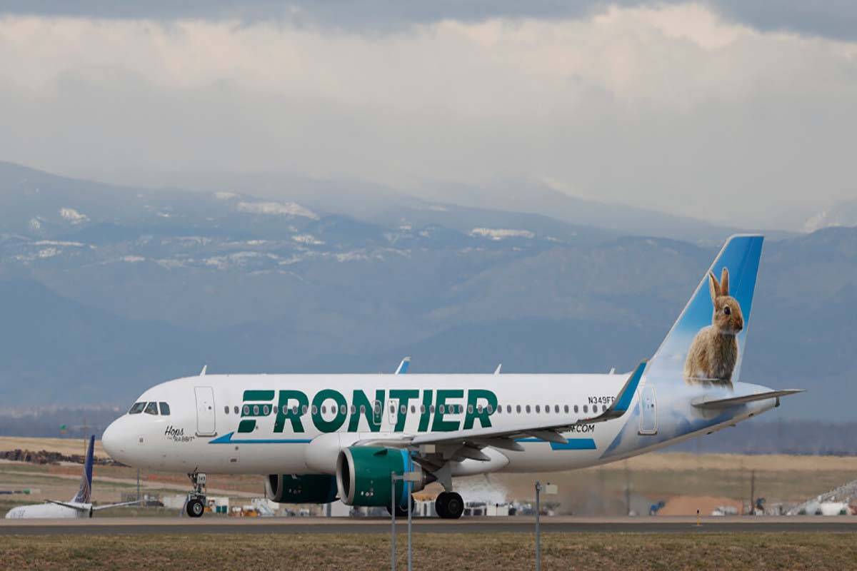 FILE - A Frontier Airlines jetliner taxis to a runway to take off from Denver International Air ...