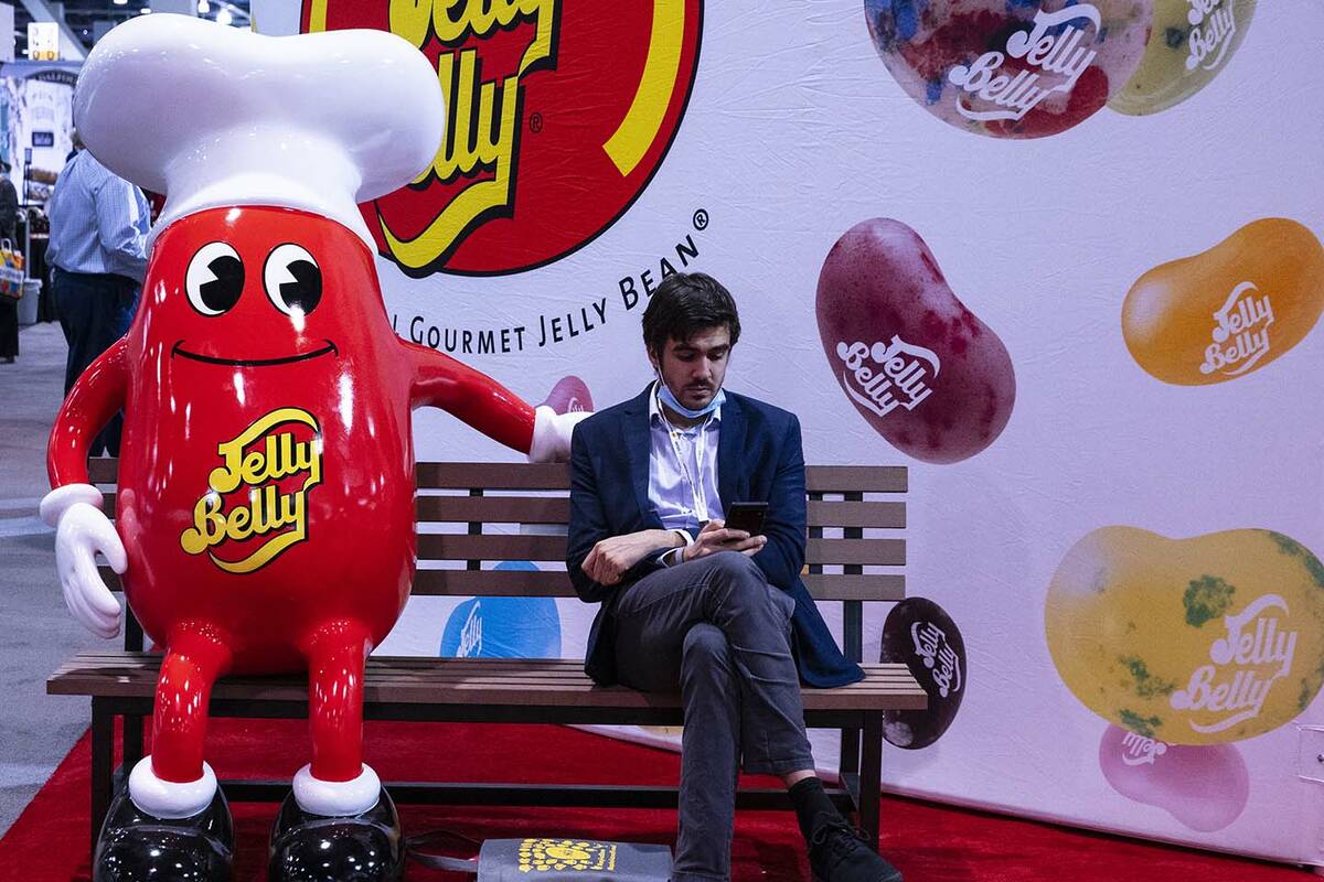 Michael Arnouts of Belgium checks his phone as he takes a break at the Fancy Food Show at the L ...