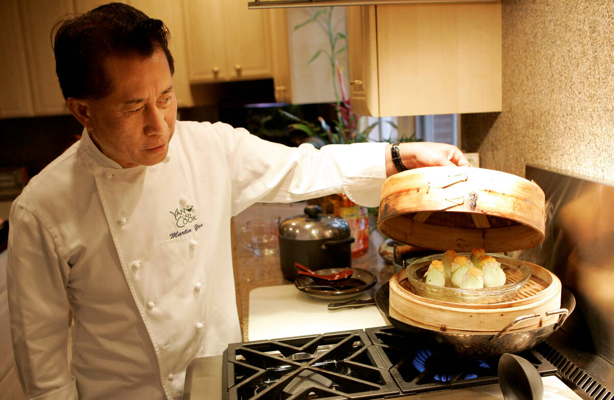Chef Martin Yan checks on a shrimp mousse tulip appetizer at his home in Hillsborough, Calif., ...