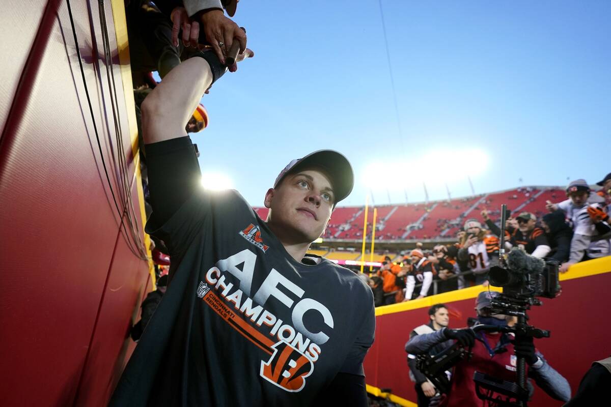 Cincinnati Bengals quarterback Joe Burrow celebrates with fans after the AFC championship NFL f ...