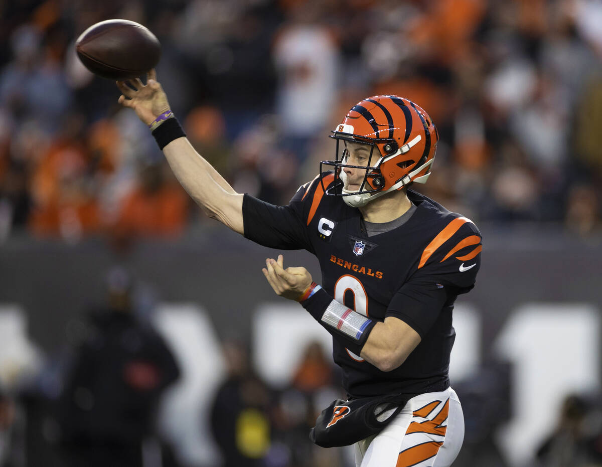 Cincinnati Bengals quarterback Joe Burrow (9) makes a throw in the first half during an NFL pla ...