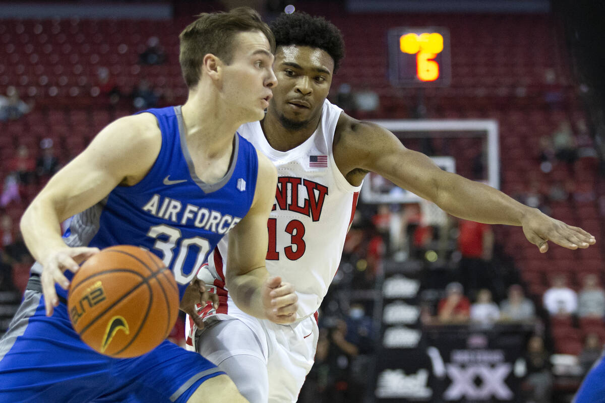 Air Force Falcons guard Camden Vander Zwaag (30) drives around UNLV Rebels guard Bryce Hamilton ...