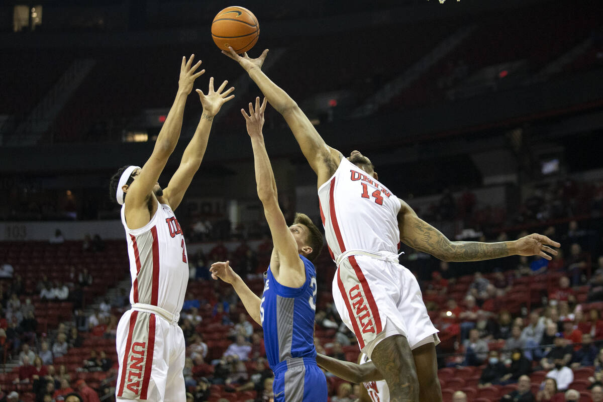 UNLV Rebels forward Royce Hamm Jr. (14) blocks a shot by Air Force Falcons center Lucas Moerman ...